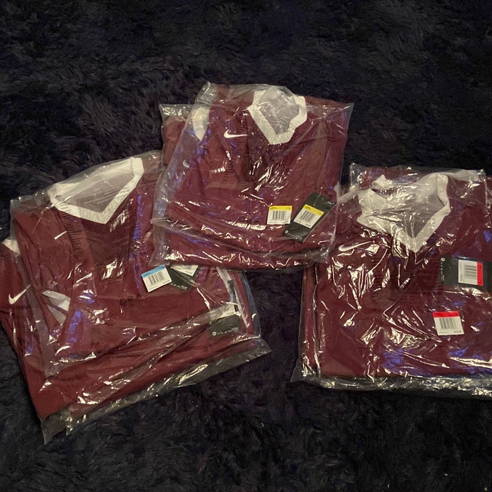 Womens Nike long sleeve volleyball shirt. Various sizes. Color is maroon.